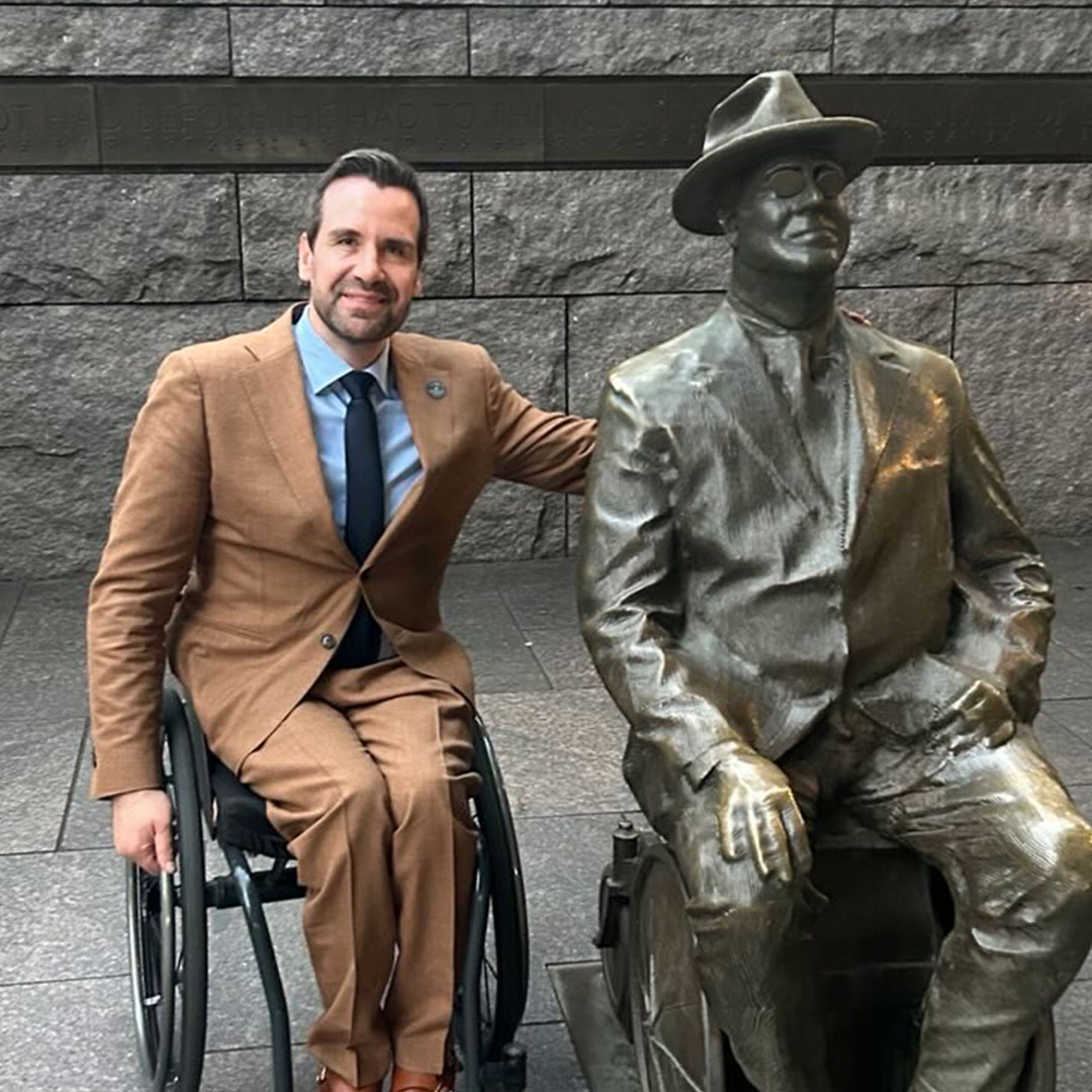 Josh Turek beside the seated statue of Franklin Delano Roosevelt at the FDR Memorial